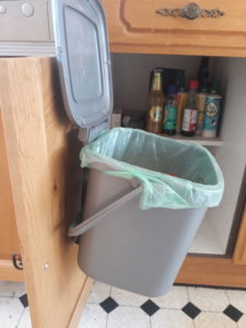 Household food waste caddy on a hook