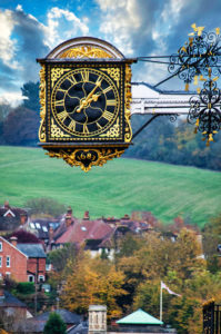 A 336 year old clock hangs over the streets and houses of Guildford High Street