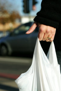 A womans hand holds a shopping bag